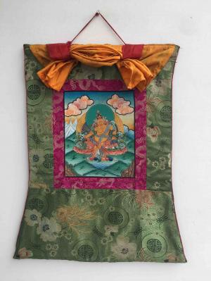 Small Yellow Dzambala Thangka Mounted on a Green Flower Pattern Silk Brocade | Buddhist Dharmapala